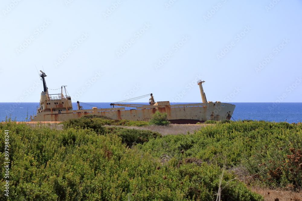 Shipwreck of the abandoned ship Edro III on a rocky coast at Akrotiri Beach in Cyprus