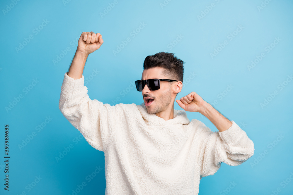 Photo portrait of cool guy with stubble dancing isolated on pastel blue colored background Photo portrait of cool guy with stubble dancing isolated on pastel blue colored background