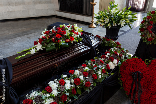 A coffin decorated with flowers. Beautiful farewell ceremony.