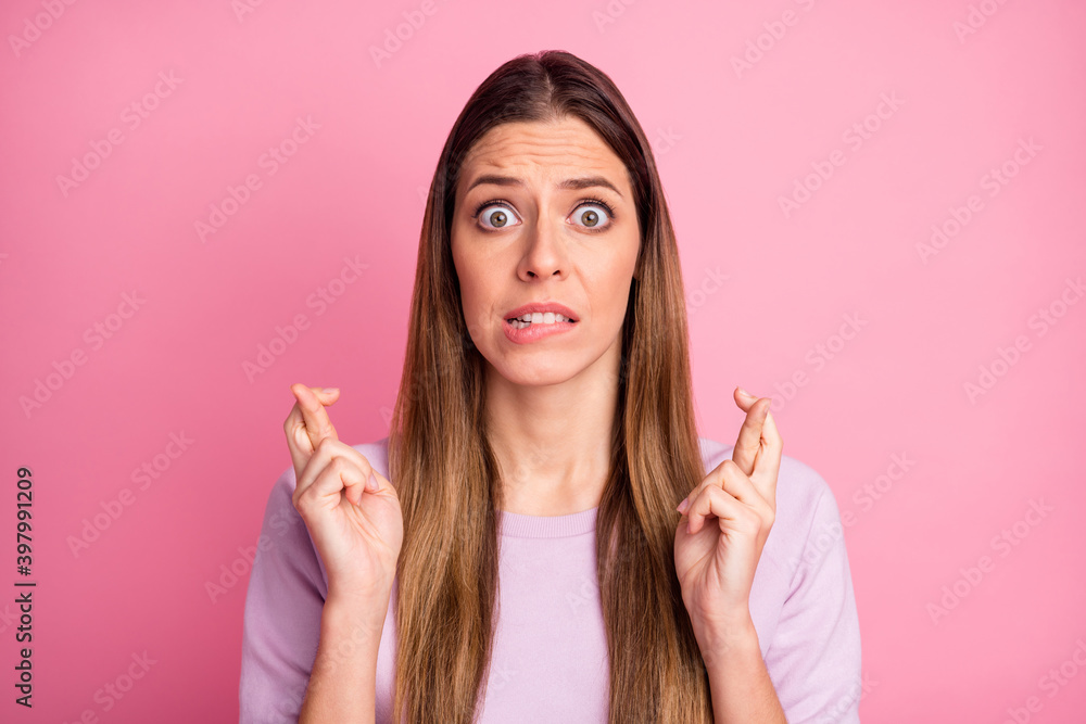 Close-up portrait of pretty confused straight-haired girl asking favor expecting crossed fingers isolated over pink color background Close-up portrait of pretty confused straight-haired girl asking favor expecting crossed fingers isolated over pink color background