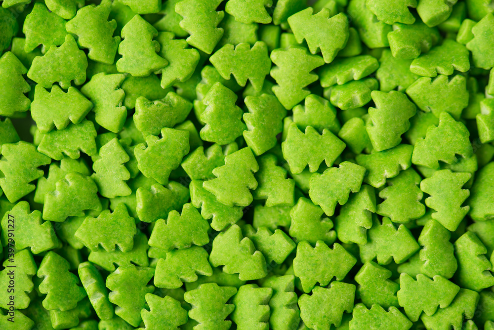 Close up above view photo of background made of little christmas trees in vibrant green color Close up above view photo of background made of little christmas trees in vibrant green color