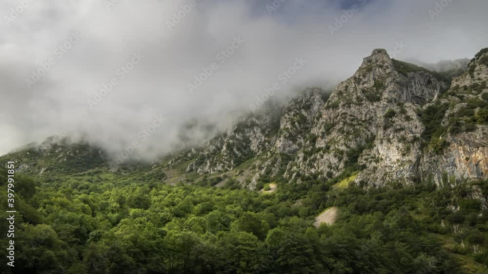 Mountain landscape time lapse with a lush forest, evolving fogs and a rock mountain Mountain landscape time lapse with a lush forest, evolving fogs and a rock mountain