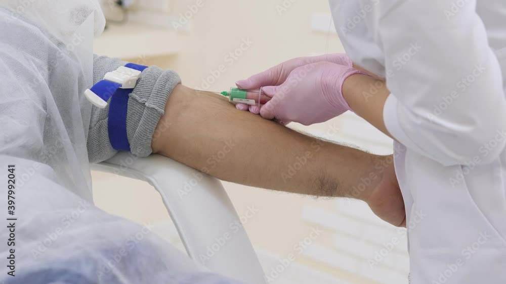 Laboratory with nurse taking a blood sample from patient close up Laboratory with nurse taking a blood sample from patient close up