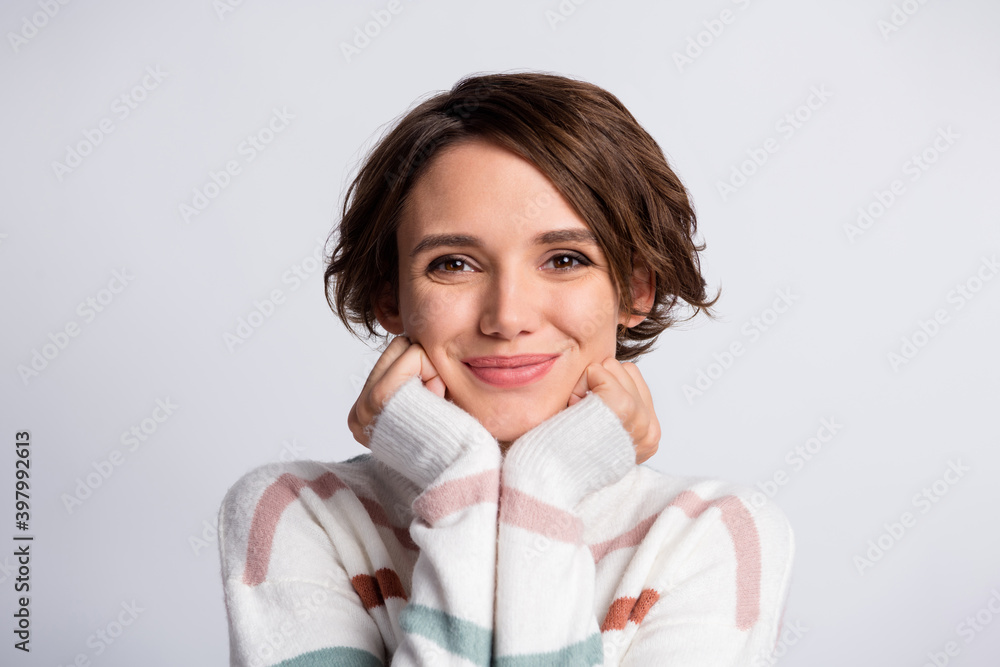 Close-up portrait of lovely cute cheery brown-haired girl enjoying wearing warm clothing isolated over grey pastel color background Close-up portrait of lovely cute cheery brown-haired girl enjoying wearing warm clothing isolated over grey pastel color background