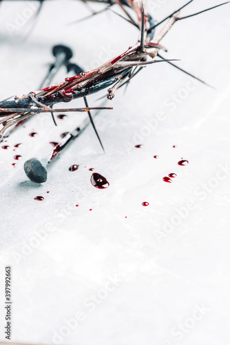 Fotografie Bloody nails, crown of thorns, drops of blood on grey stone background