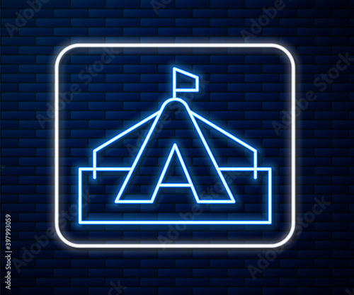 Glowing neon line Tourist tent icon isolated on brick wall background. Camping symbol. Vector.