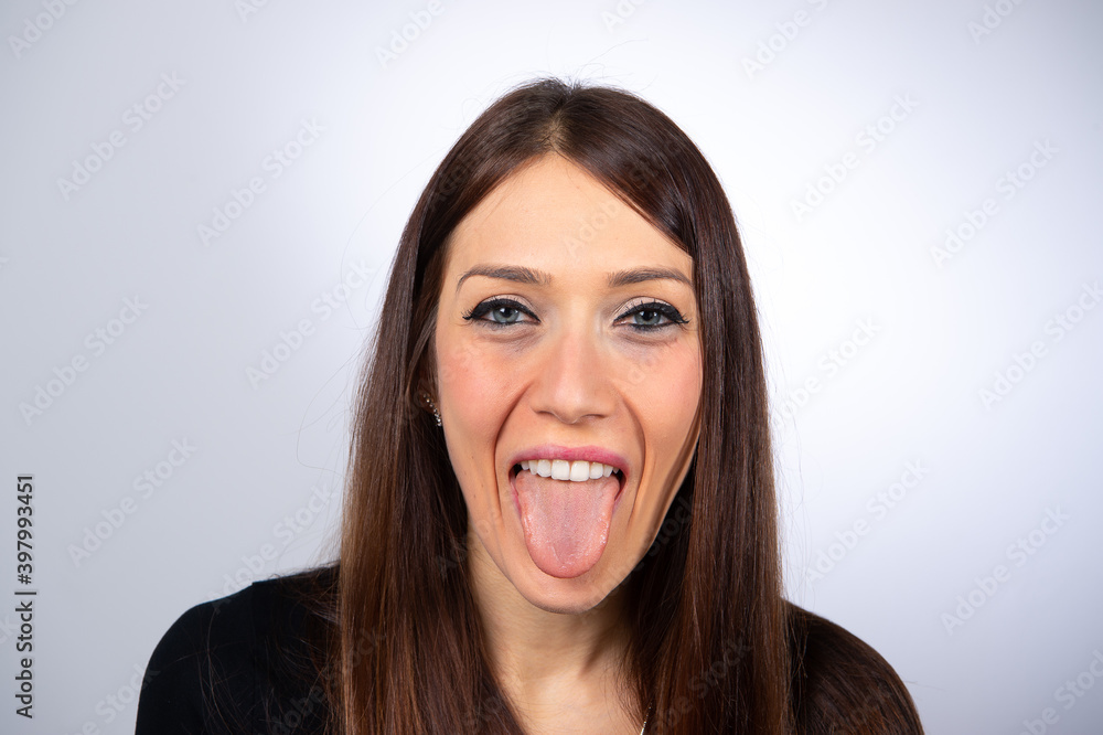 Tongue hanging out woman isolated on white background Tongue hanging out woman isolated on white background