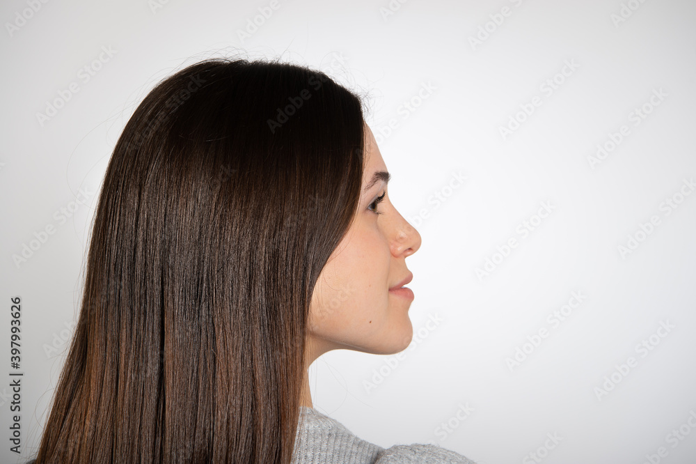 Young woman looking to left , studio portrait isolated on white background, copy space Young woman looking to left , studio portrait isolated on white background, copy space