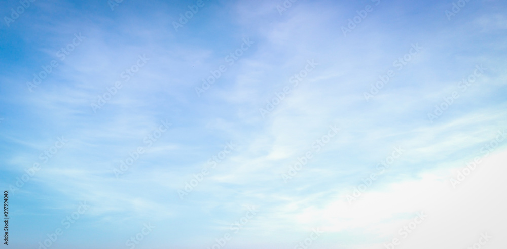 Bright blue sky and soft white clouds