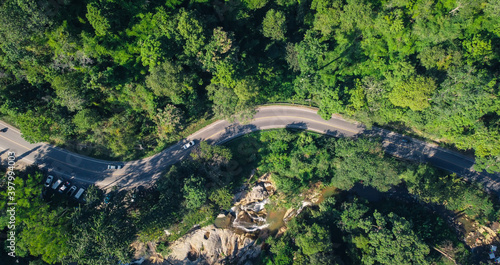 Aerial view of mountain road and green forest in Thailand.