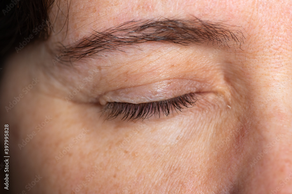 Fototapeta premium A closed woman's eye and eyelashes