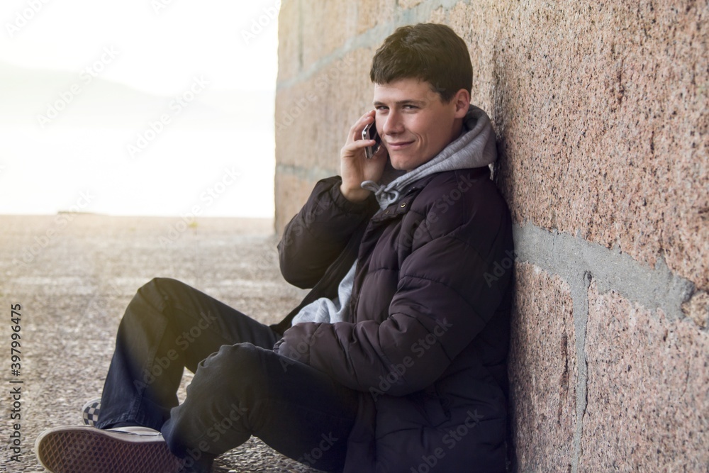 smiling man using smartphone or mobile phone