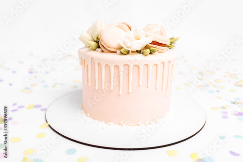 White beautiful cake decorated with flowers, birthday and wedding cake, on isolated white background
