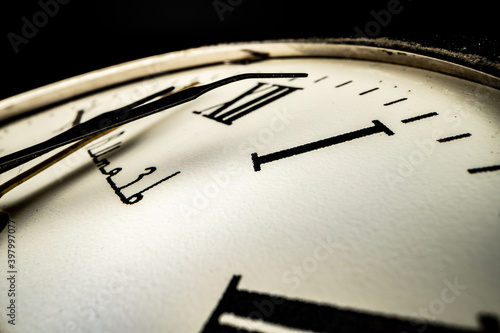 Old metal watch dial in dark macro photo