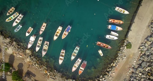 Birds eye view of a group of small fishing boats tied in a small marina photo