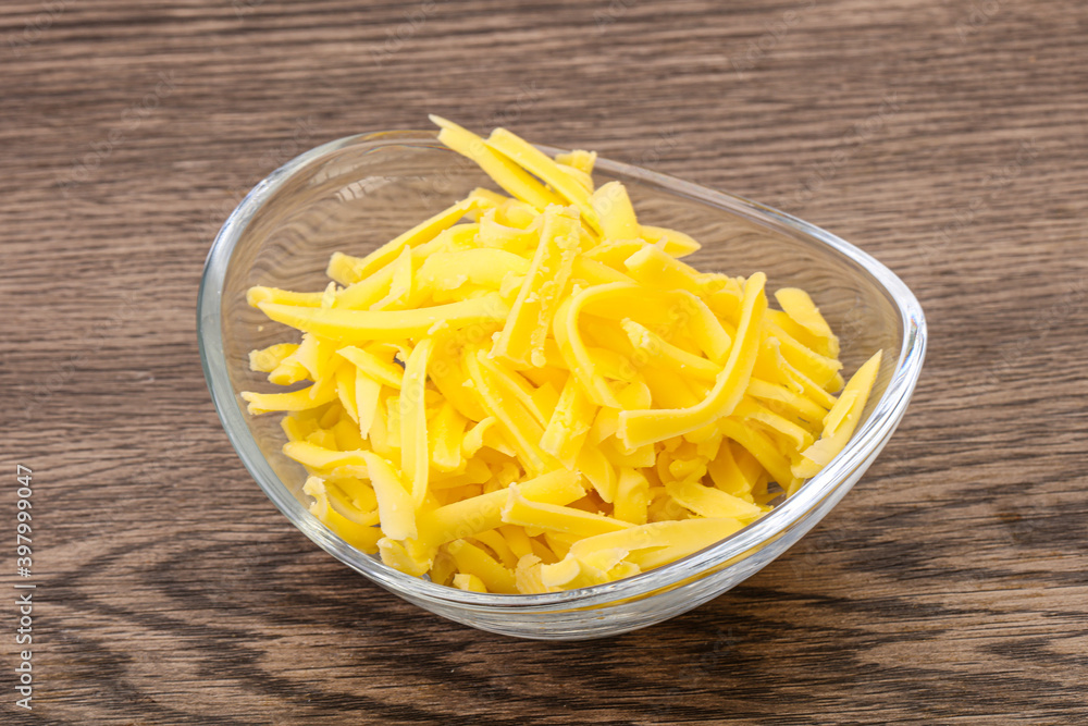 Shredded yellow cheese in the bowl Shredded yellow cheese in the bowl