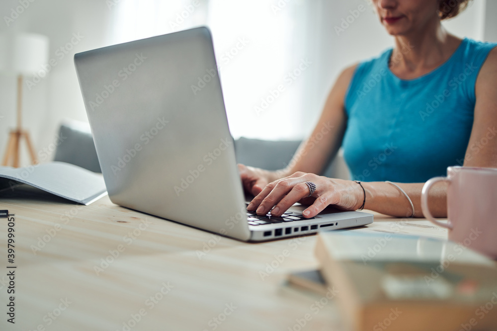 Woman working from home, using laptop / notebook, modern freelance concept. Woman working from home, using laptop / notebook, modern freelance concept.