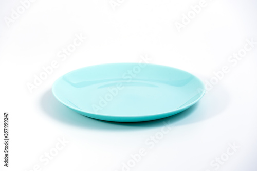 Empty Turquoise plate isolated on white background side view, selective focus