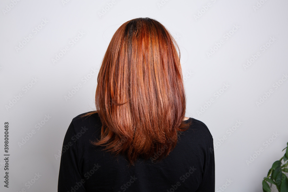 Half body portrait of rear view of a brown-haired woman wear black clothes over white background Half body portrait of rear view of a brown-haired woman wear black clothes over white background
