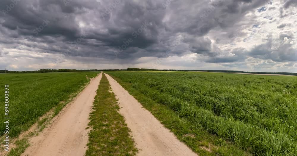 slow transformation of landscape into tiny planet on gravel road on overcast sky with beautiful storm clouds. curvature of space. slow transformation of landscape into tiny planet on gravel road on overcast sky with beautiful storm clouds. curvature of space.