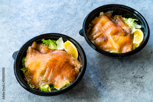 Take Away Salmon Gravlax Salad in Black Plastic Bowl Container and Mustard Sauce Package.