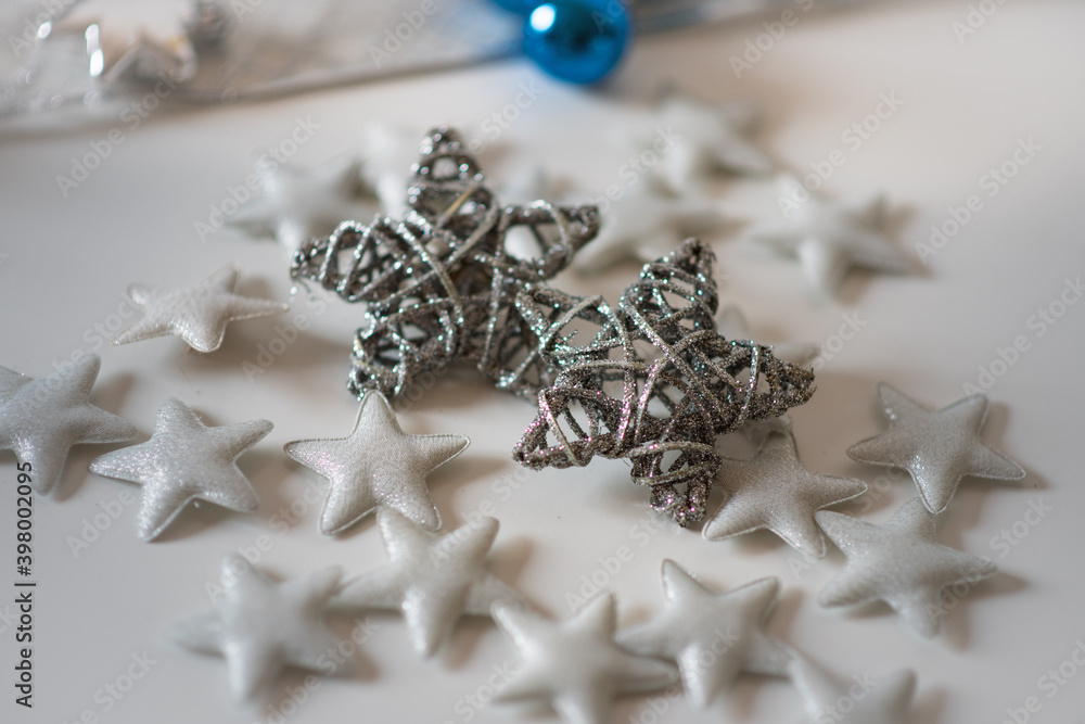 Christmas decoration on white background. Cozy silver blue christmas star and christmas ornaments. Christmas decoration on white background. Cozy silver blue christmas star and christmas ornaments.