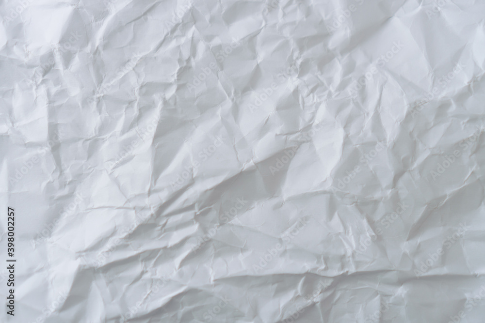 Fototapeta premium Top view of white crumpled paper texture background.