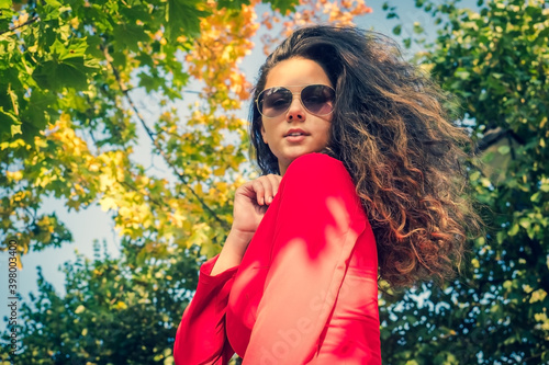 young beautiful girl brunette in sunglasses in Park in autumn