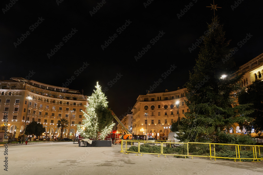 Thessaloniki, Greece - December 6 2020: Decorating Christmas tree at Aristotelous square. Night view of festive instalments at the southern part of main city square.