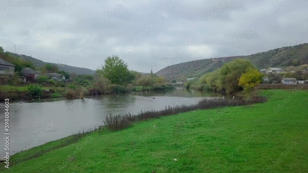 Drone flight over the river and smal moldavian village in autumn landscape. Moldova republic of. Drone flight over the river and smal moldavian village in autumn landscape. Moldova republic of.