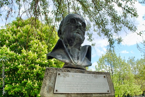 The Bust of John Dalton against blue sky with English explanation plate at METU greenery park. Dalton is an English scientist, best known for introducing the atomic theory into chemistry.  photo