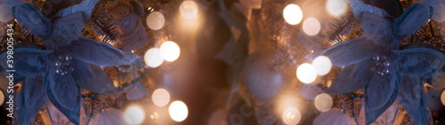 Festive background with a decorated Christmas tree, New Year's toys, holiday lights, neon lights, garland. Dark background with blurred bokeh.