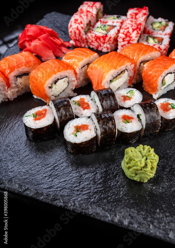 Japanese cuisine. Sushi with fresh ingredients on a black background.