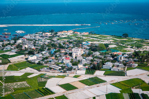 high view from Thoi Loi Mountain, fishing village and garlic fields at Ly Son island, Quang Ngai Province, Viet Nam photo