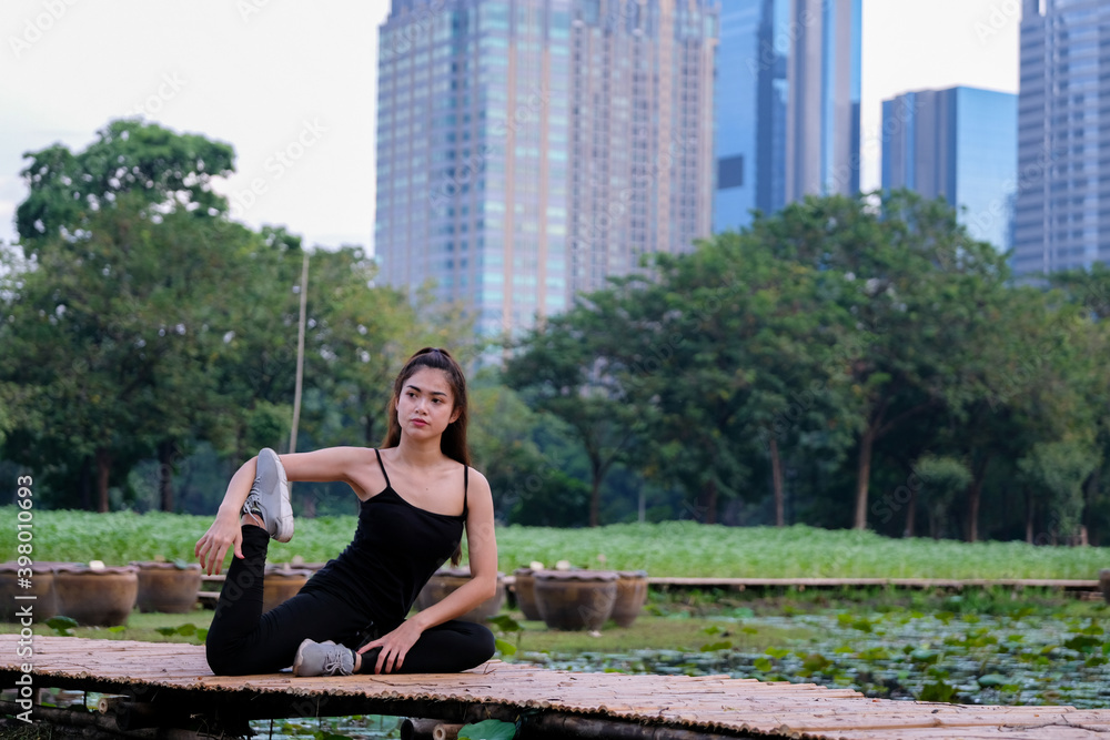 Portrait of fit and sporty young woman doing stretching in park. Sport, training and lifestyle concept. Portrait of fit and sporty young woman doing stretching in park. Sport, training and lifestyle concept.