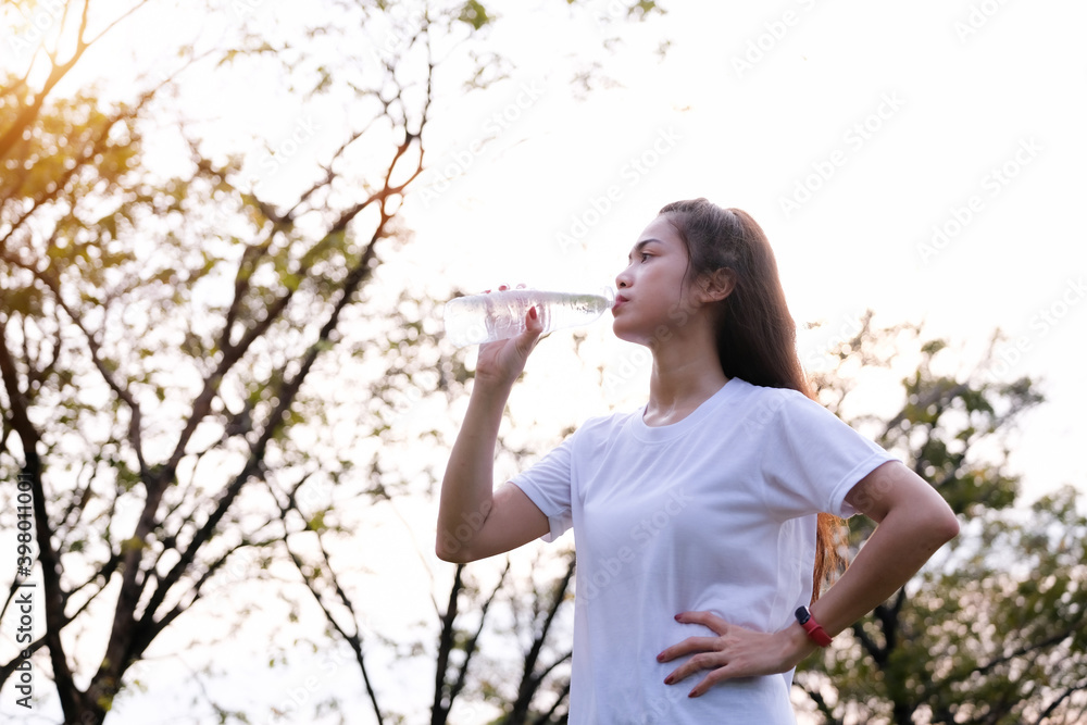 Asian young woman drinking water after exercise, healthy and sport concept. Asian young woman drinking water after exercise, healthy and sport concept.