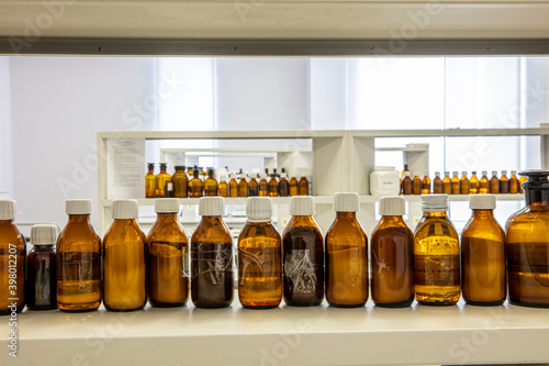 Close up amber color bottles in laboratory. Amber bottle for storing scientific samples. photo