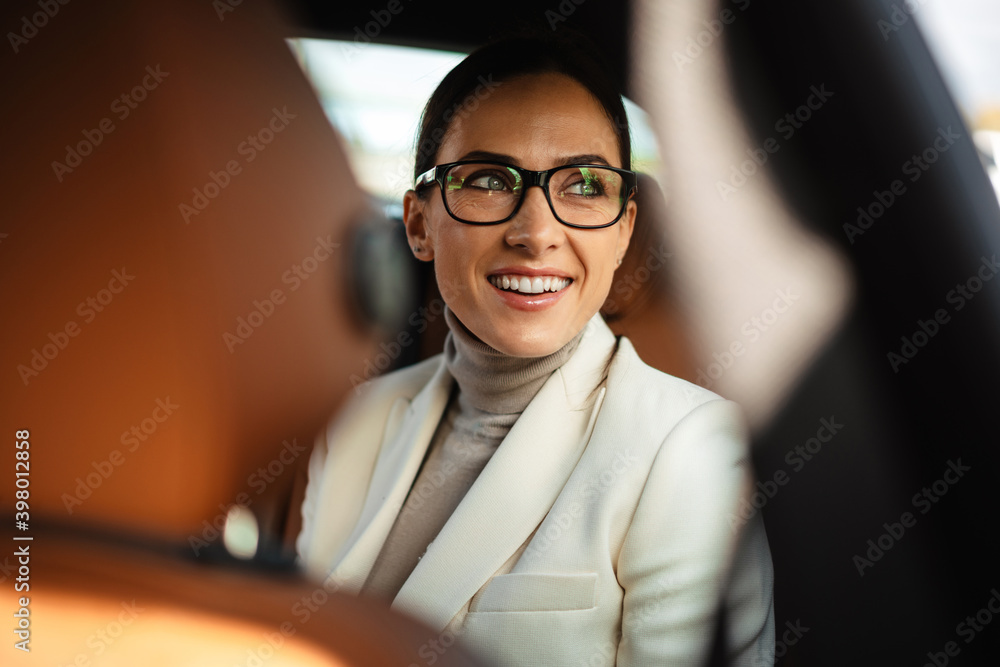 Positive pleased business woman sitting in a car - obrazy, fototapety, plakaty 