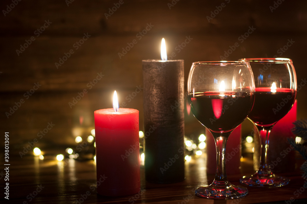 Wine in the grocery. Burning candles in the dark. The concept of Christmas and New Year comfort Wine in the grocery. Burning candles in the dark. The concept of Christmas and New Year comfort
