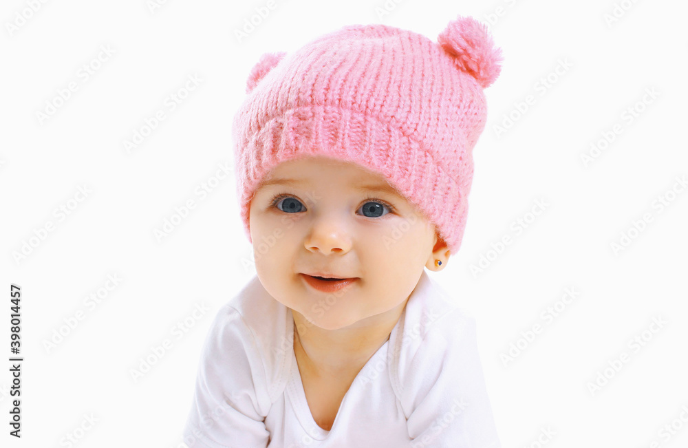 Portrait close up of sweet baby wearing a knitted pink hat over a white background Portrait close up of sweet baby wearing a knitted pink hat over a white background