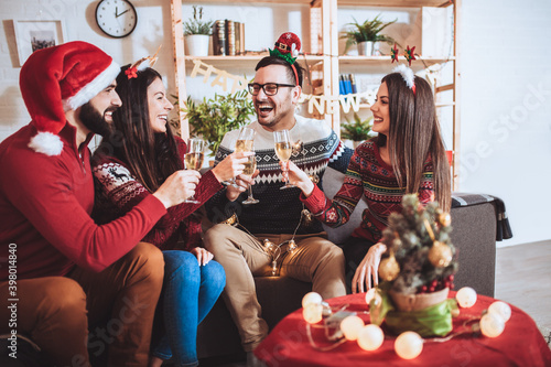 Group of young friends having fun at a New Year s celebration at home.