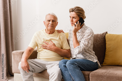 Fotografija Anxious woman  calling to 911 emergency line because her elderly father with a c