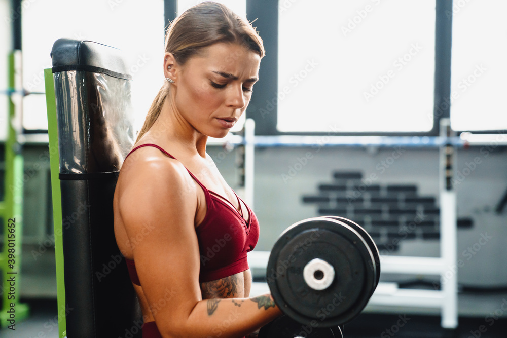 Concentrated serious young woman fitness coach Concentrated serious young woman fitness coach