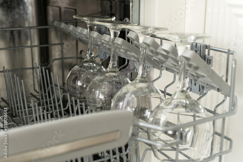 glasses of wine are stacked rhythmically in the dishwasher.