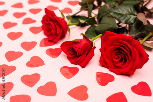 red hearts and roses on pink background