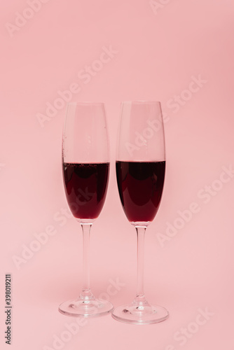 red wine in glasses isolated on pink