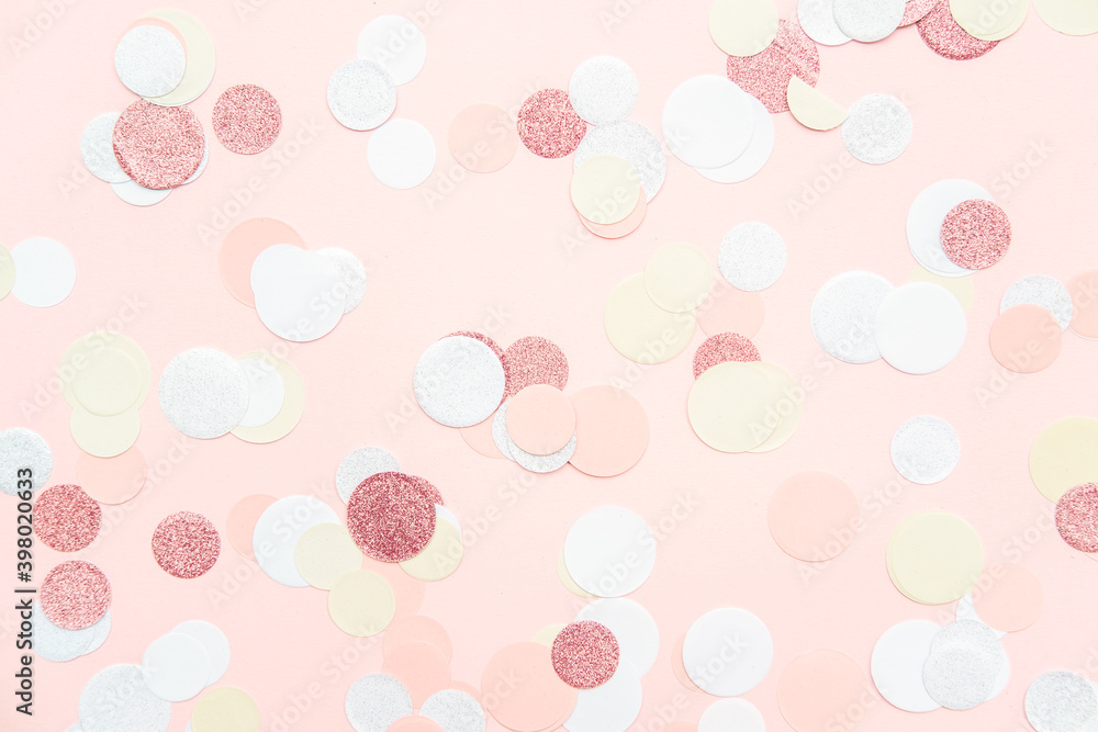 Multicolor pink, gold and white confetti on the light peach pink background, holiday celebration backdrop, Flat lay style with place for text Multicolor pink, gold and white confetti on the light peach pink background, holiday celebration backdrop, Flat lay style with place for text