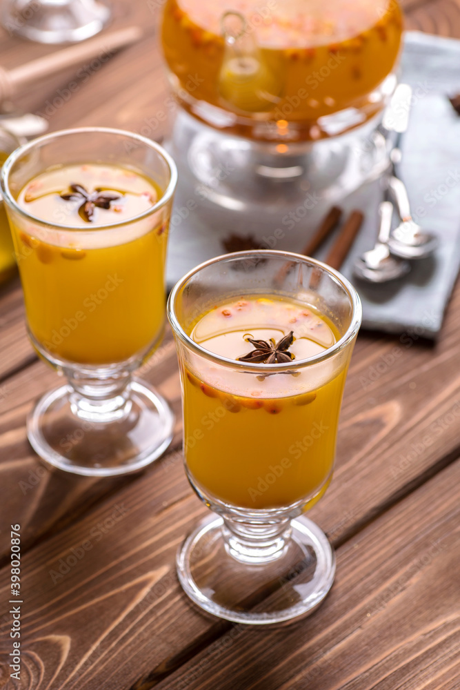 Beautiful glass teapot with orange sea buckthorn tea. Hot winter drinks, Beautiful glass teapot with orange sea buckthorn tea. Hot winter drinks,