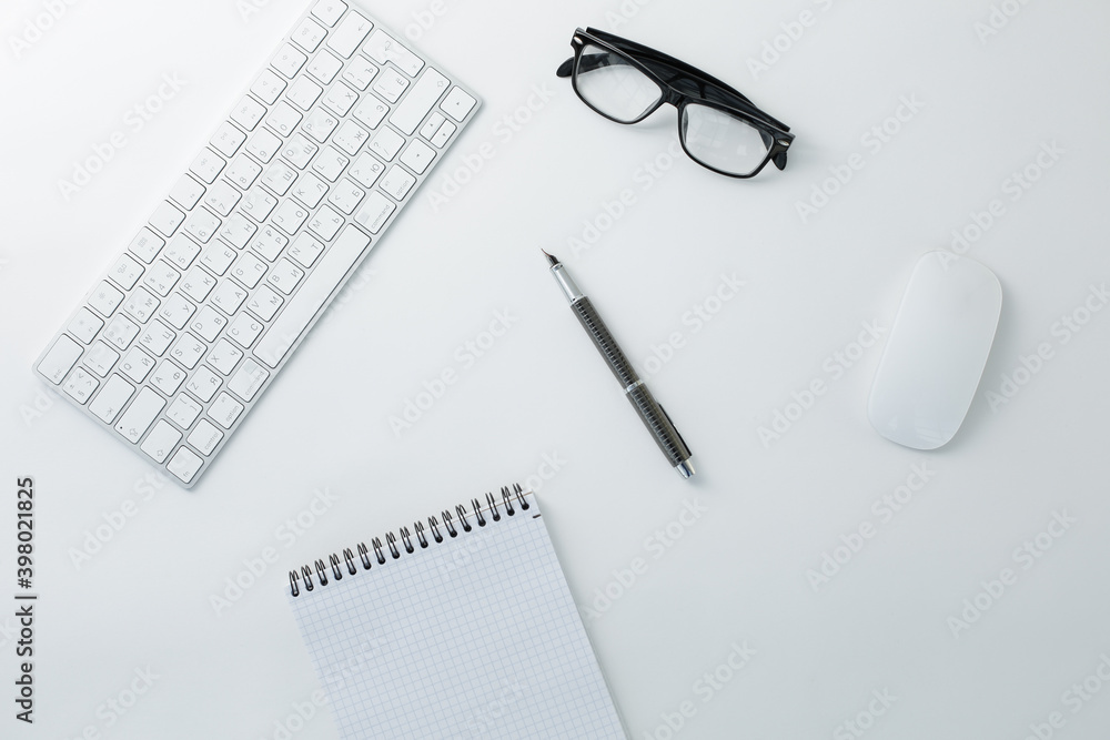 Glasses keyboard mouse notepad and pen on white background Glasses keyboard mouse notepad and pen on white background