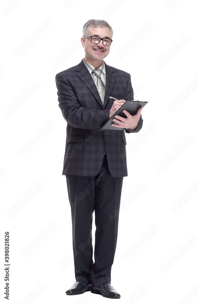 in full growth. business man making an entry in the clipboard. in full growth. business man making an entry in the clipboard.